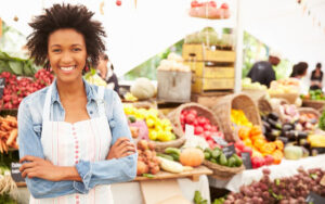 A vegetable vendor smiling